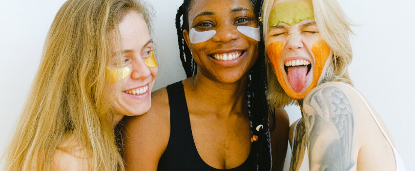 women with natural facial masks having fun 