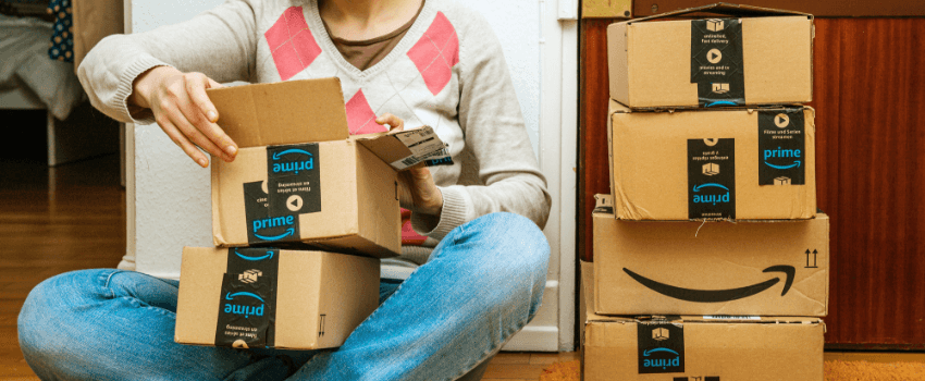 woman unboxing amazon cardboard