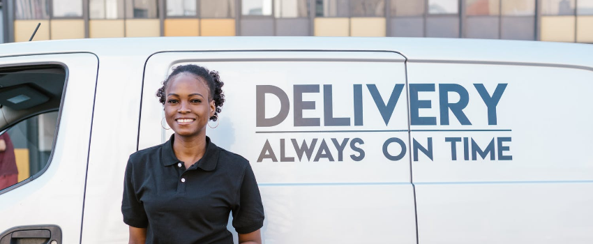 delivery woman standing in front of the van