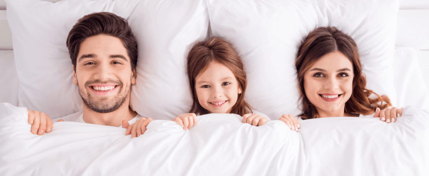 family in bed purchased during labor day deals