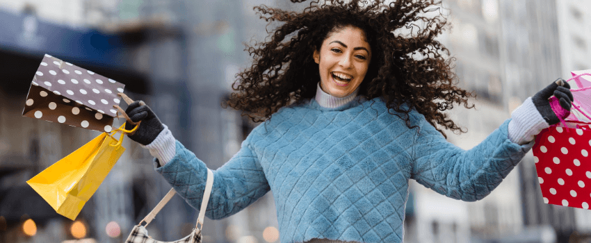 happy woman holding shopping bags during labor day sales